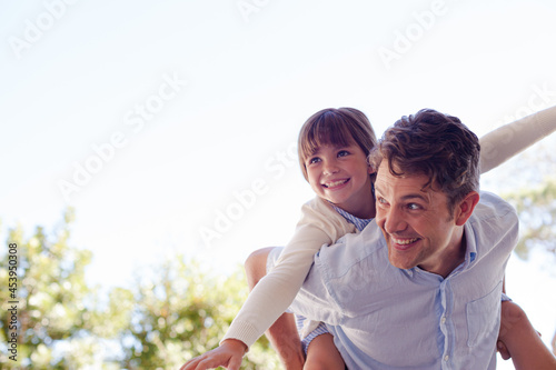 Father and daughter hugging outdoors