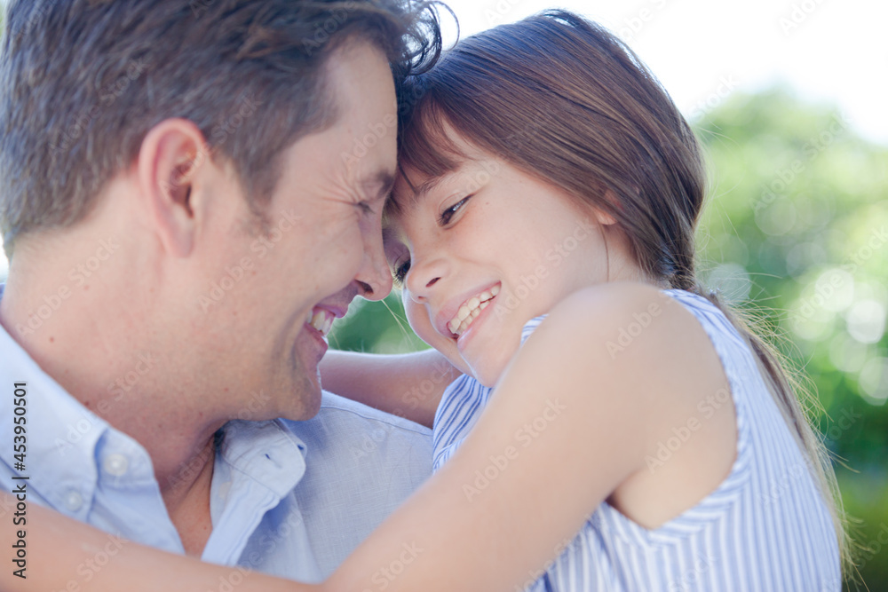 Father and daughter hugging outdoors Father and daughter hugging outdoors