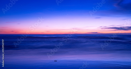 Beautiful motion blur long exposure sunset or sunrise with dramatic sky clouds over calm sea in tropical phuket island Amazing nature view and light of nature seascape.