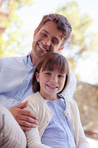 Father and daughter hugging outdoors © KOTO