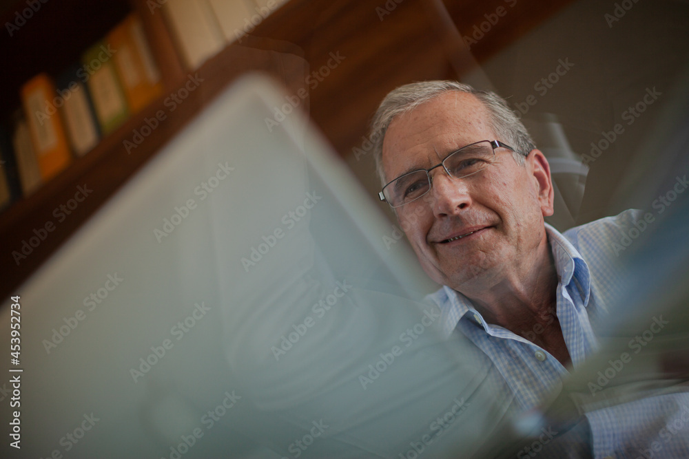 Fototapeta premium Older man working at desk