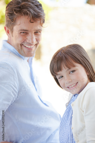 Father and daughter smiling outdoors © KOTO