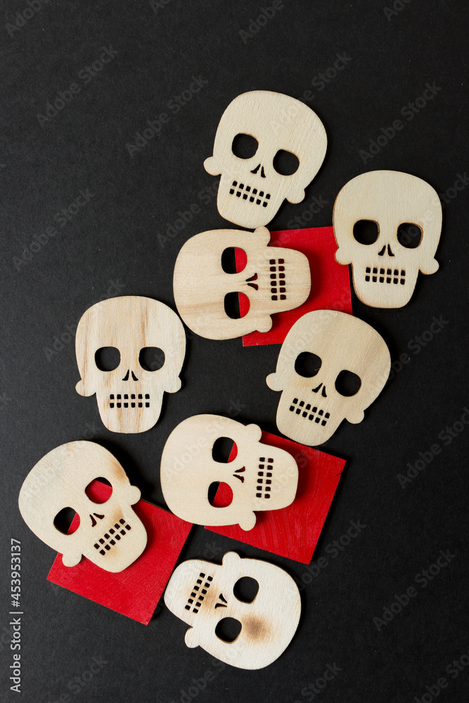 halloween theme with wooden shapes arranged on a black paper background halloween theme with wooden shapes arranged on a black paper background