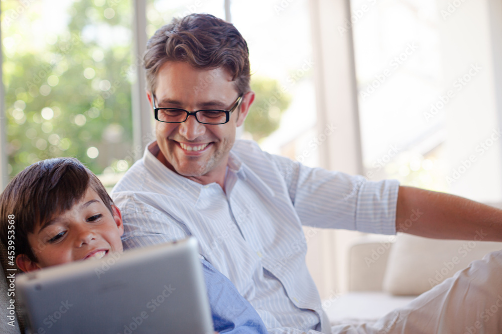 Fototapeta premium Father and son using tablet computer