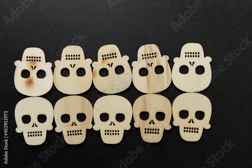 halloween theme with wooden shapes arranged on a black paper background photo