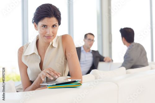 Businesswoman using tablet computer in office