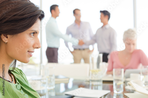 Businesswoman smiling at meeting table