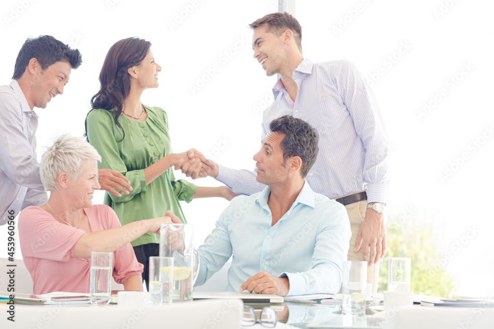 Business people shaking hands in meeting Business people shaking hands in meeting