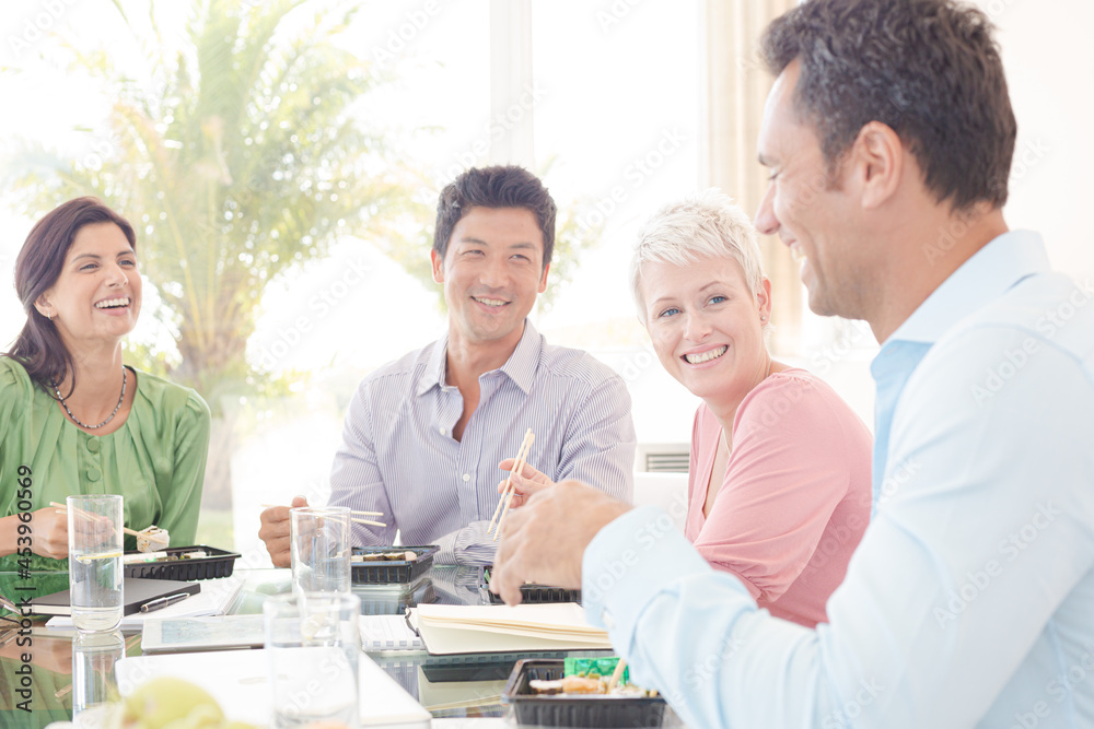 Business people smiling in lunch meeting Business people smiling in lunch meeting