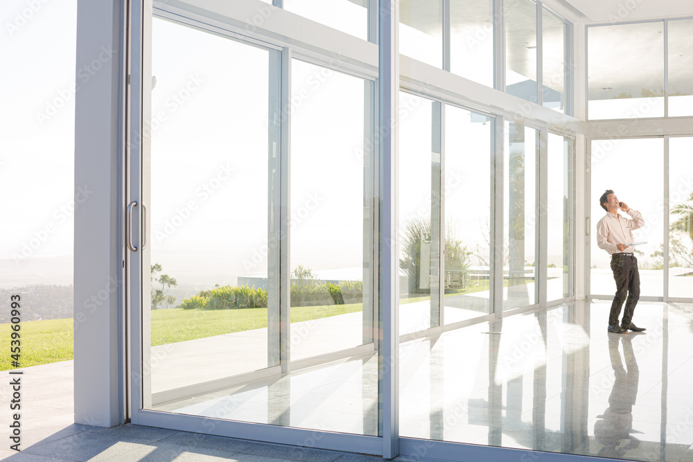 Businessman standing at office window Businessman standing at office window