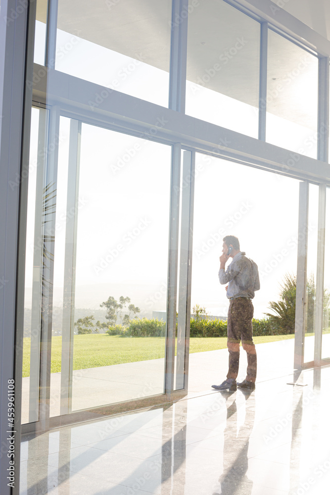 Businessman talking on cell phone outdoors Businessman talking on cell phone outdoors