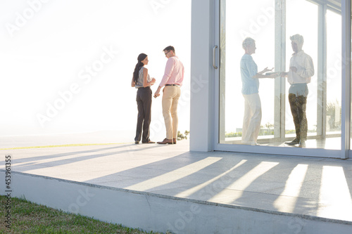 Business people talking outside office