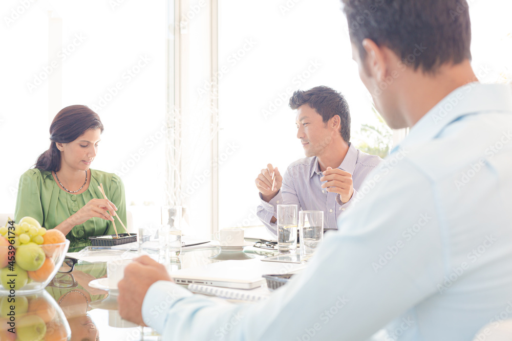 Business people smiling in lunch meeting