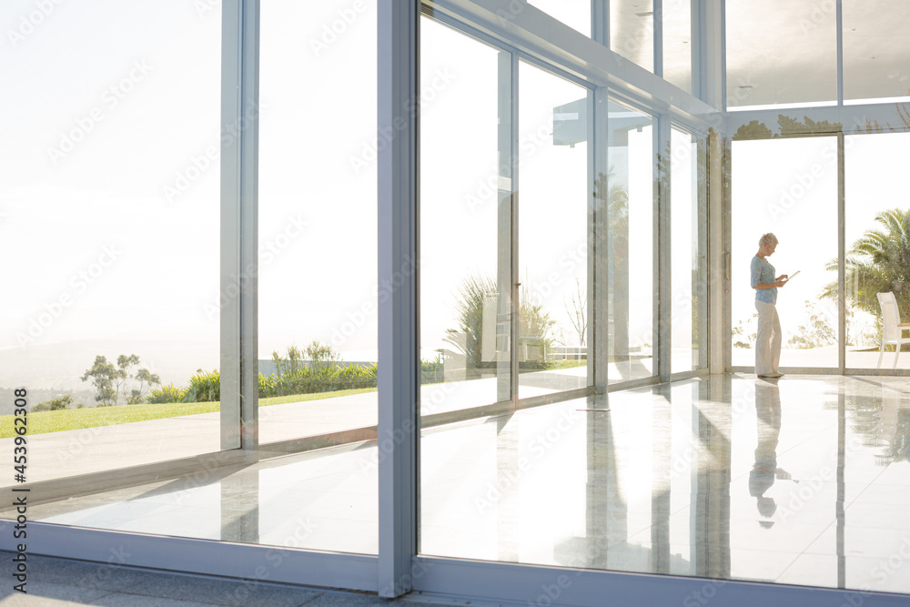 Businessman standing at office window Businessman standing at office window