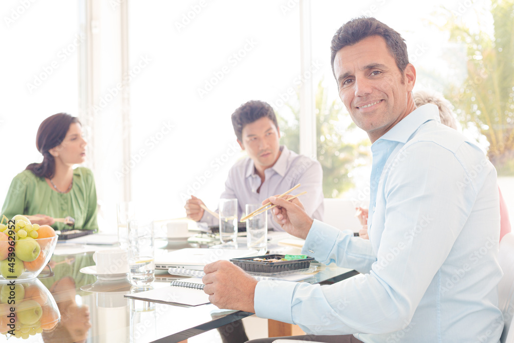 Businessman smiling in lunch meeting