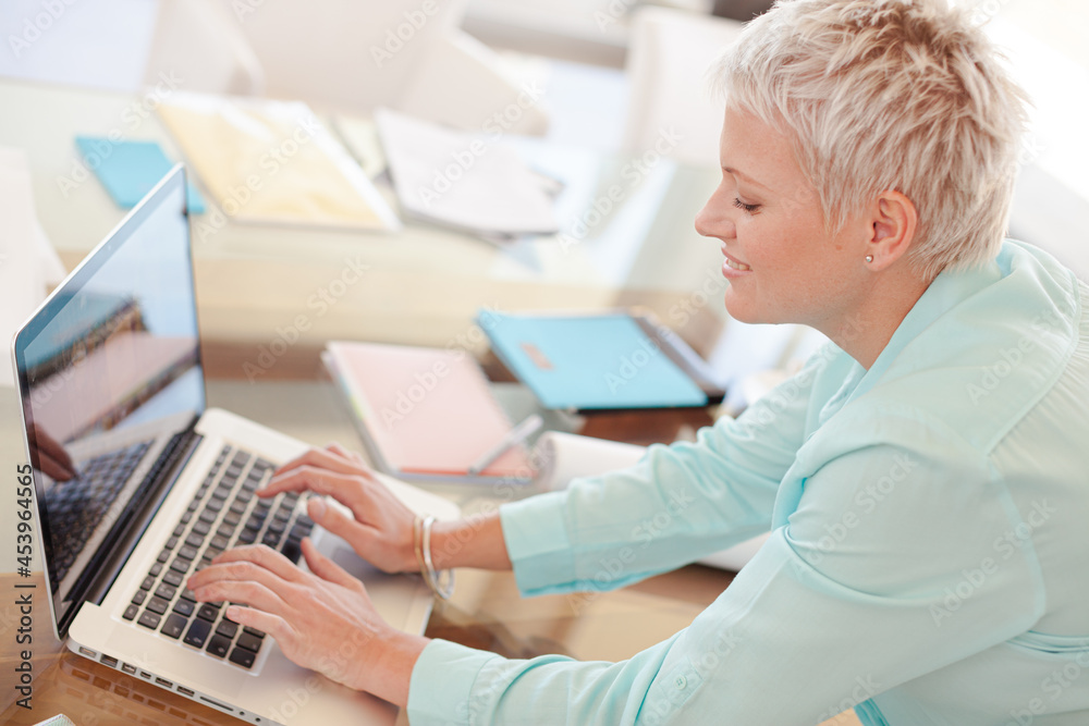 Businesswoman using laptop at desk Businesswoman using laptop at desk