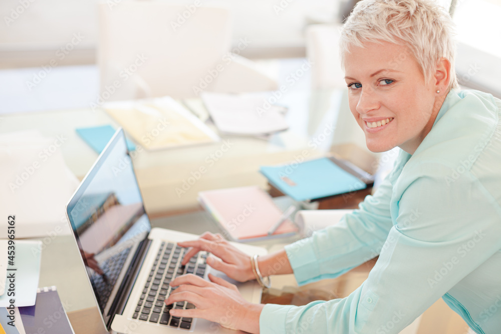 Businesswoman using laptop at desk Businesswoman using laptop at desk