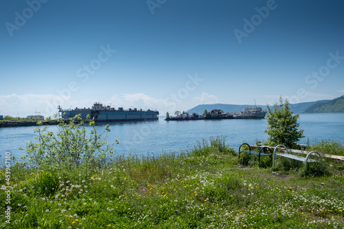 Summer landscape with ships on lake Baikal. Coastline of most deep clear lake in the world