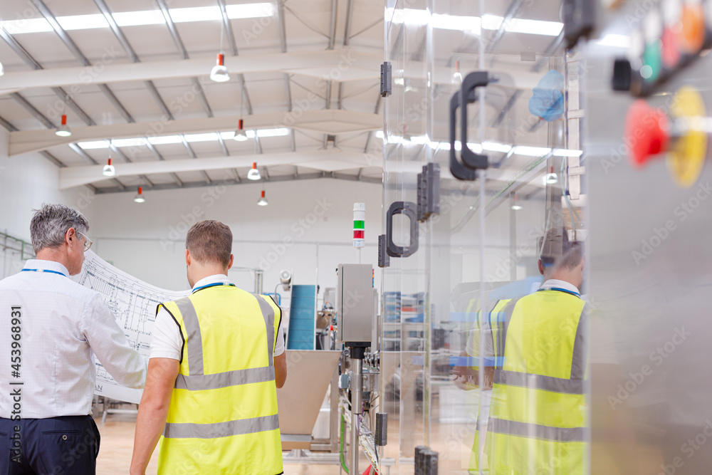 Supervisor and worker talking in warehouse Supervisor and worker talking in warehouse