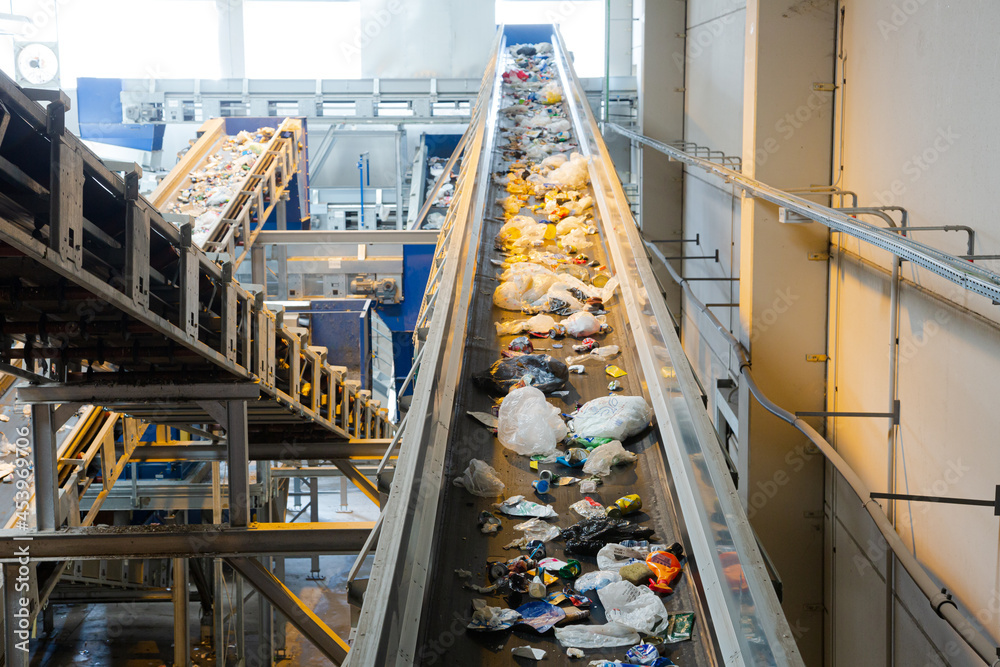 Recycled material on conveyor belt in recycling center Recycled material on conveyor belt in recycling center