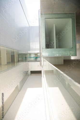 Man standing in modern building behind glass