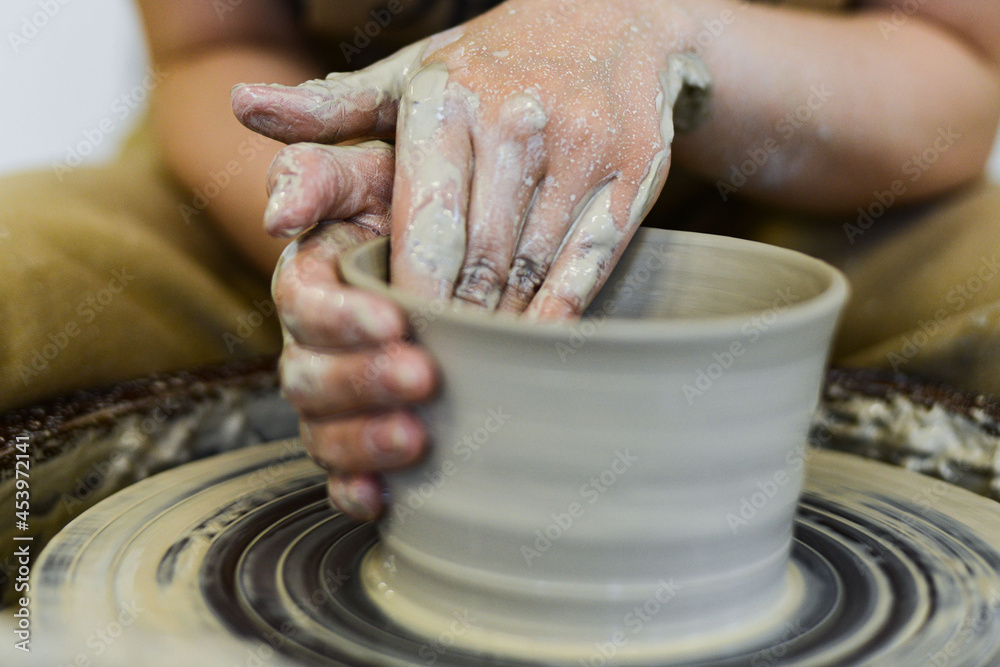 making pottery of different shape on pottery wheel