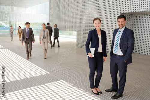 Business people standing outside modern building