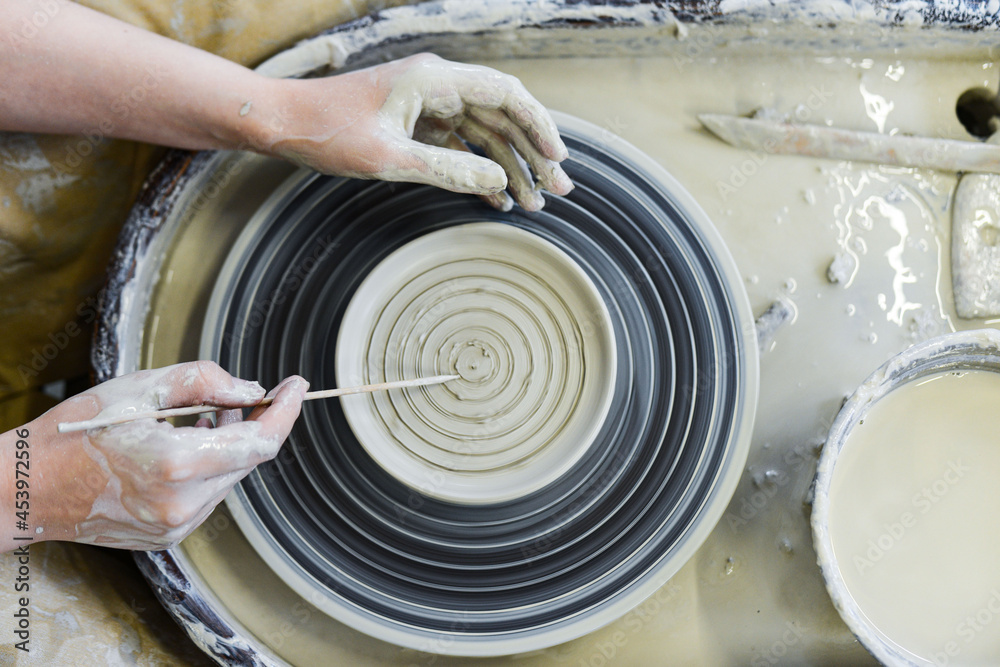 Fototapeta premium making pottery of different shape on pottery wheel