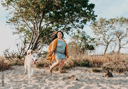 one girl and her husky dog on the beach 