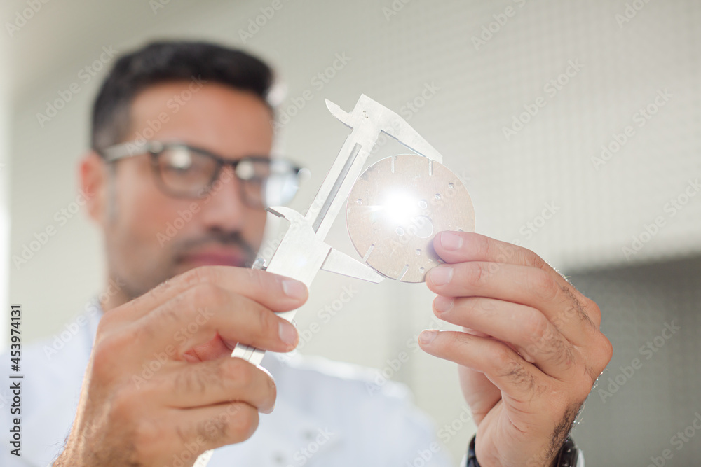 Scientist using caliper Scientist using caliper
