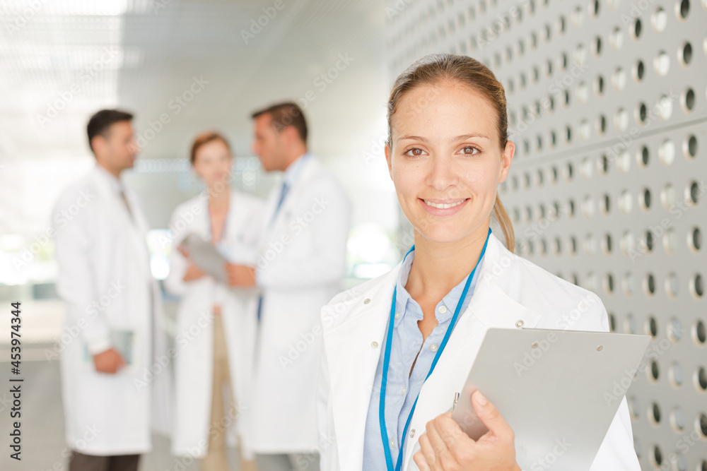 Doctor with clipboard in hospital corridor Doctor with clipboard in hospital corridor