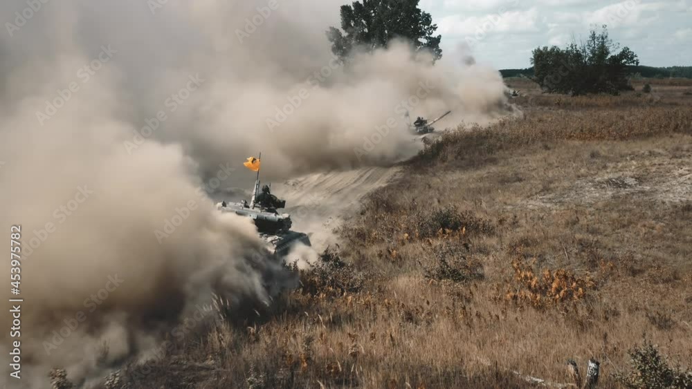 Armored military war machinery gunners on battlefield area. Tanks machines drive sandy dusty road on training demonstration. Combat defense troops vehicles of national guard. Tracking, warfare.