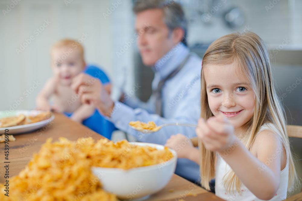 Girl eating overflowing bowl of cereal Girl eating overflowing bowl of cereal