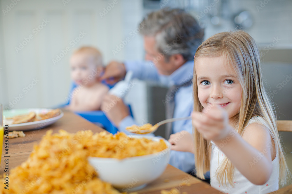 Girl eating overflowing bowl of cereal Girl eating overflowing bowl of cereal