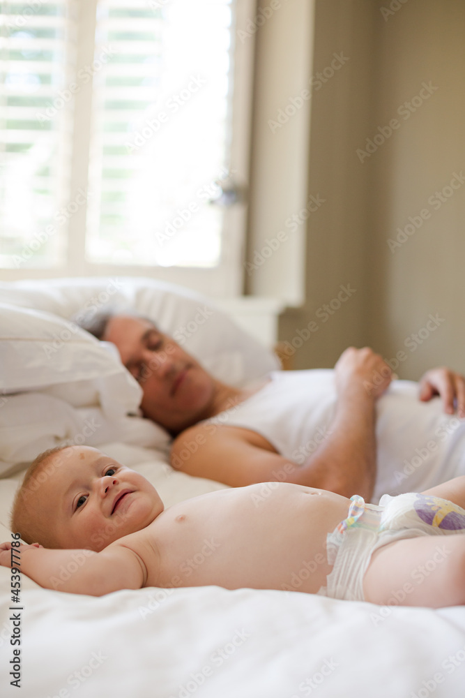 Father and baby laying on bed Father and baby laying on bed