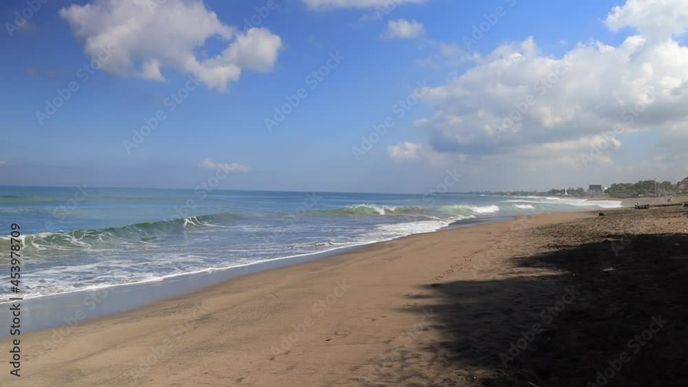 Indian ocean beach background. Sunny tropical beach. Empty beach with waves. 