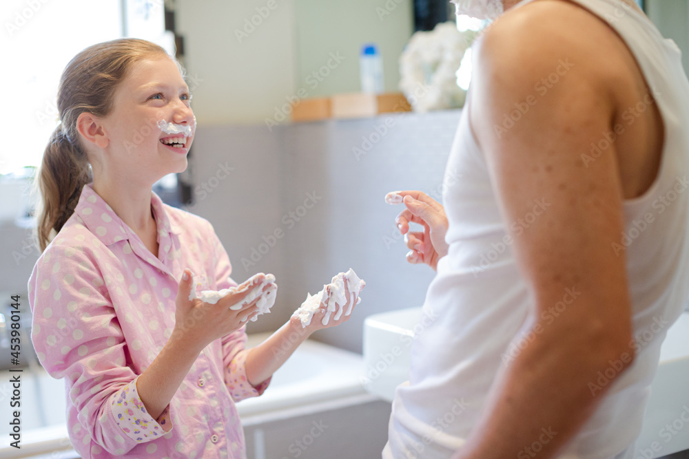 Father and daughter playing with shaving cream Father and daughter playing with shaving cream