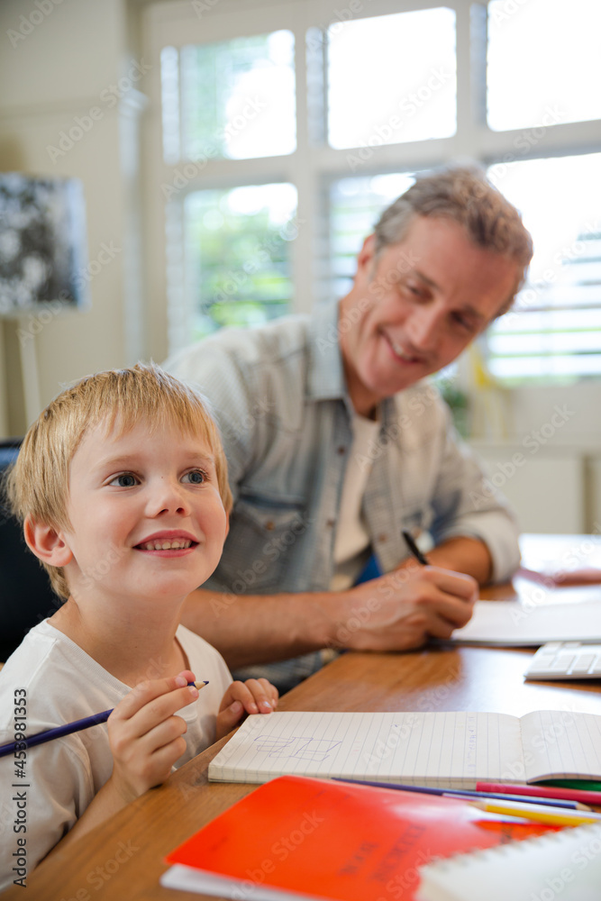 Father and son working in home office Father and son working in home office