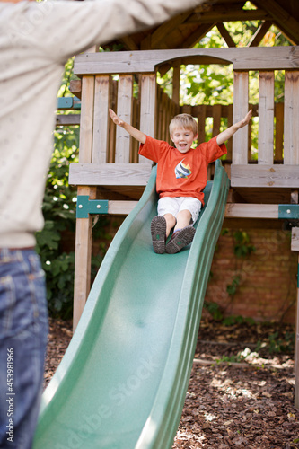 Father catching son on slide