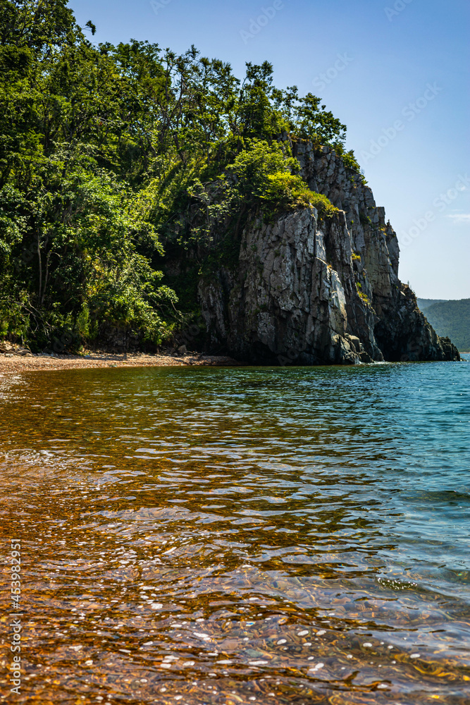 Naklejka premium Empty tropical landscape wild exotic island with mountain cliff and clear reflection sea water