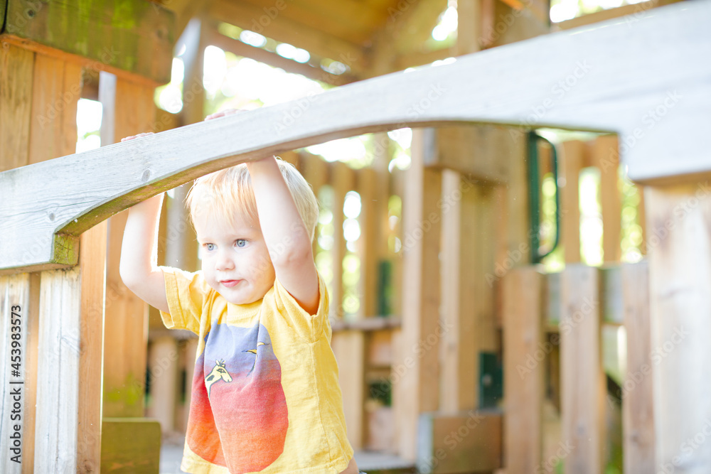 Obraz premium Boy playing on playset outdoors