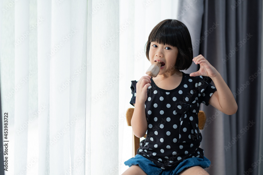 asian girl eating ice cream with blur background asian girl eating ice cream with blur background