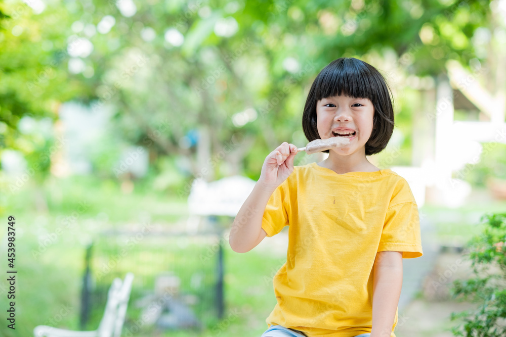 asian girl eating ice cream with blur background asian girl eating ice cream with blur background