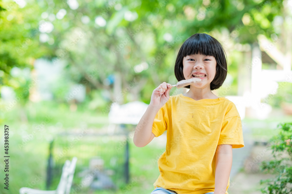 asian girl eating ice cream with blur background asian girl eating ice cream with blur background