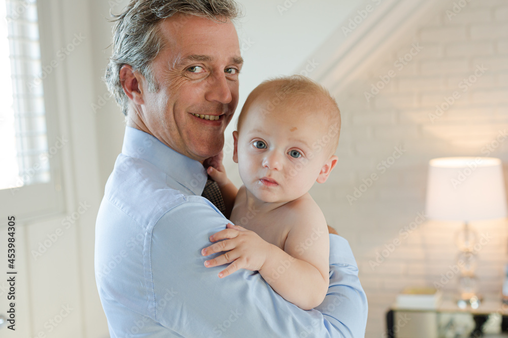 Father holding baby in bathroom Father holding baby in bathroom