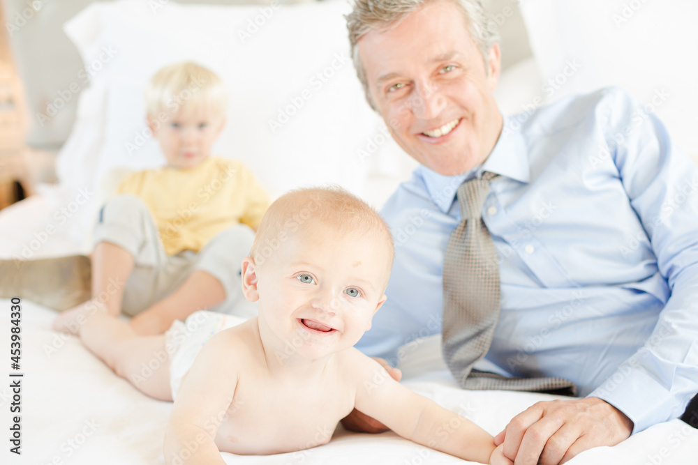 Father and children relaxing on bed Father and children relaxing on bed