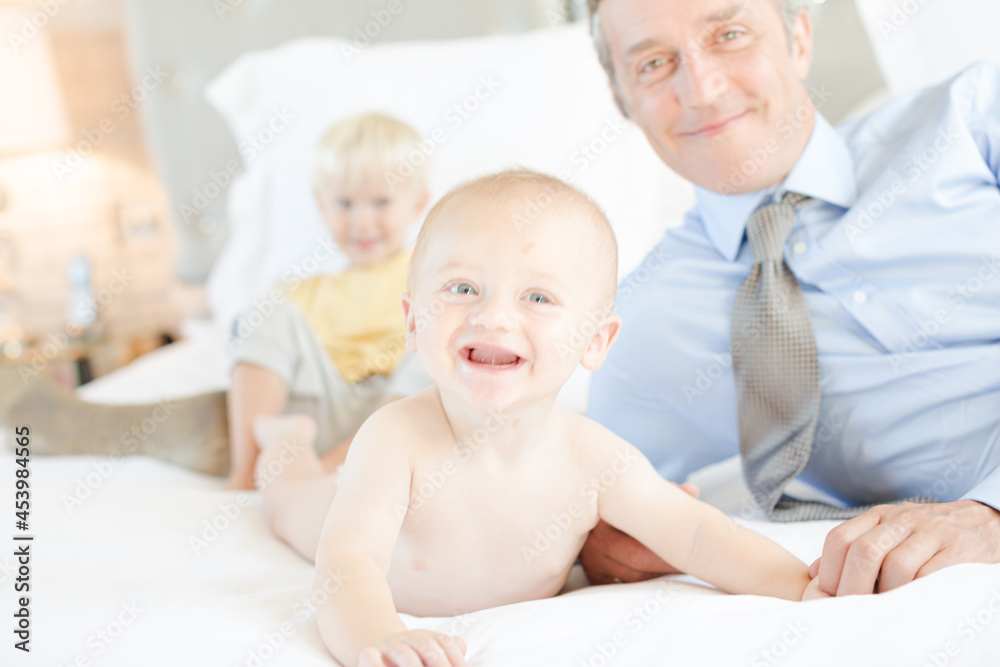 Father and children relaxing on bed Father and children relaxing on bed