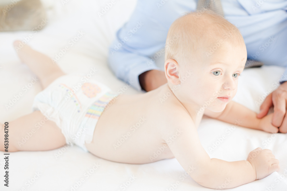 Father and baby laying on bed Father and baby laying on bed