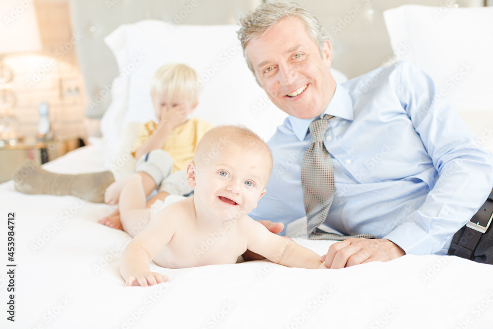 Father and children relaxing on bed Father and children relaxing on bed