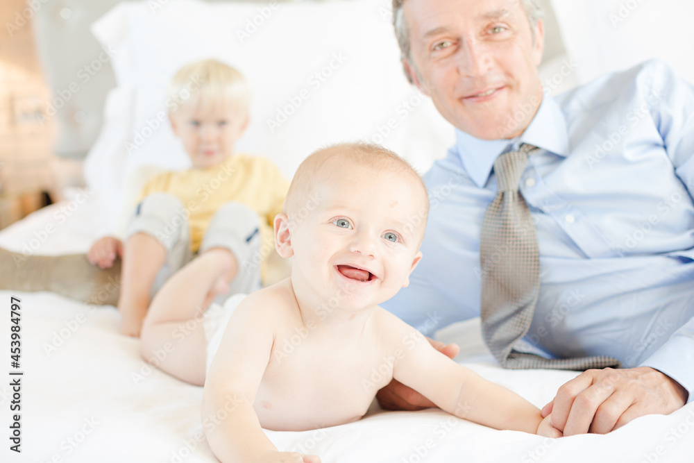 Father and children relaxing on bed Father and children relaxing on bed